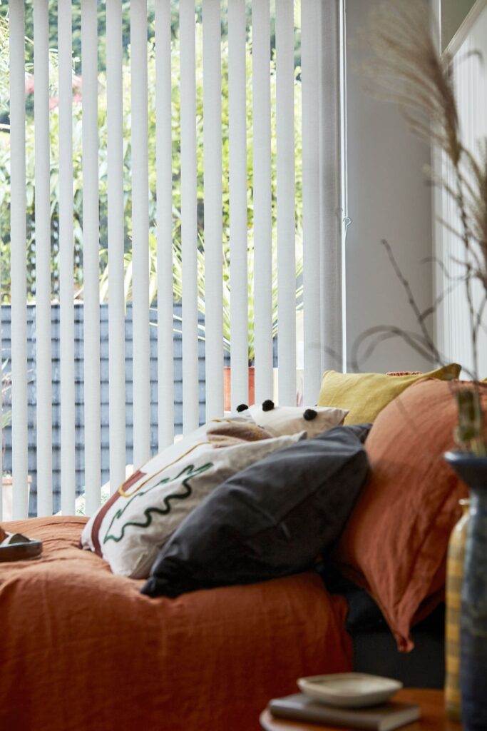 Image shows a bedroom interior with regards to how to clean vertical blinds