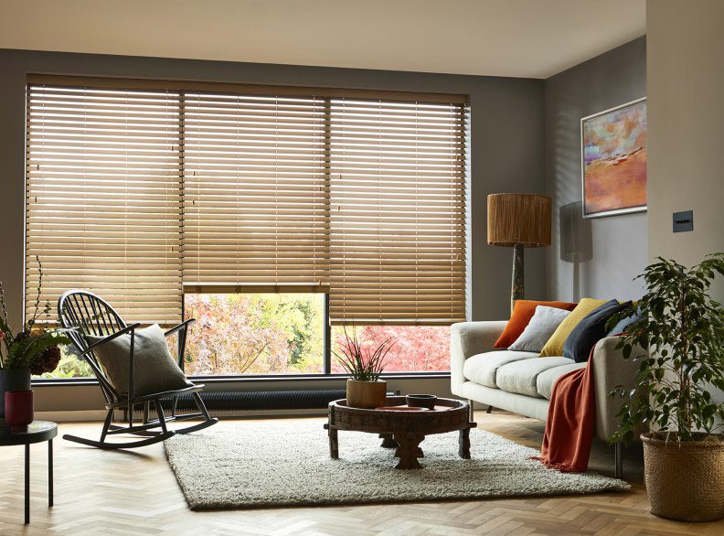 How to clean timber blinds - image shows timber Venetian blinds in a living room interior
