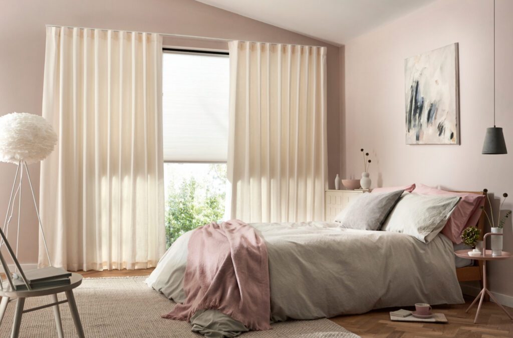 Image shows energy saving window furnishings including honeycomb blinds and s-fold curtains.