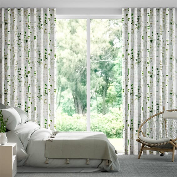 Image shows a bedroom interior with blockout s-fold curtains in a watercolour leaf design.