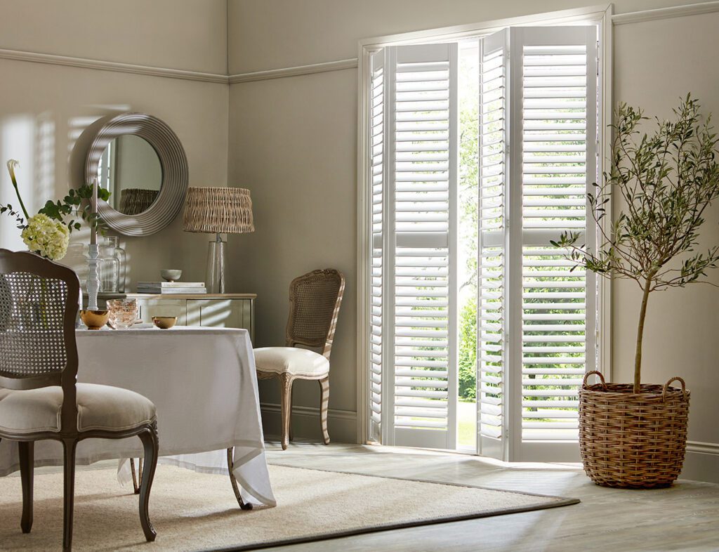 Image shows a dining room with white shutters