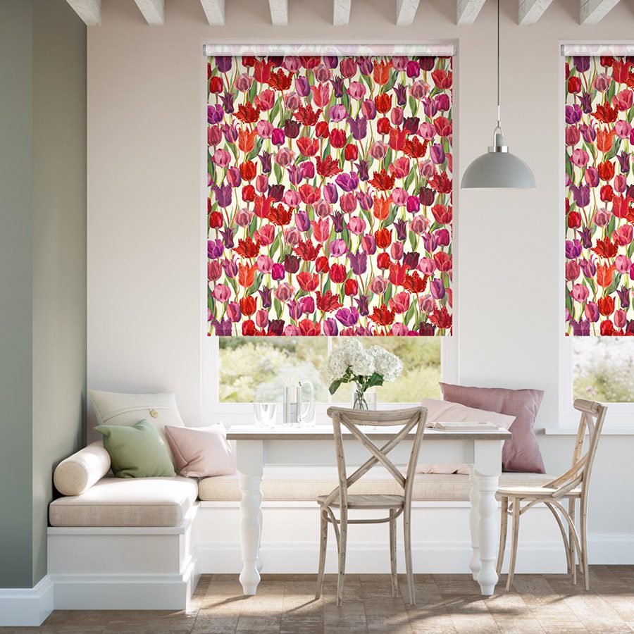 Roller blinds can be automated on our Tuiss SmartView app. Image shows designer Emma Bridgewater roller blinds in a dining corner. 