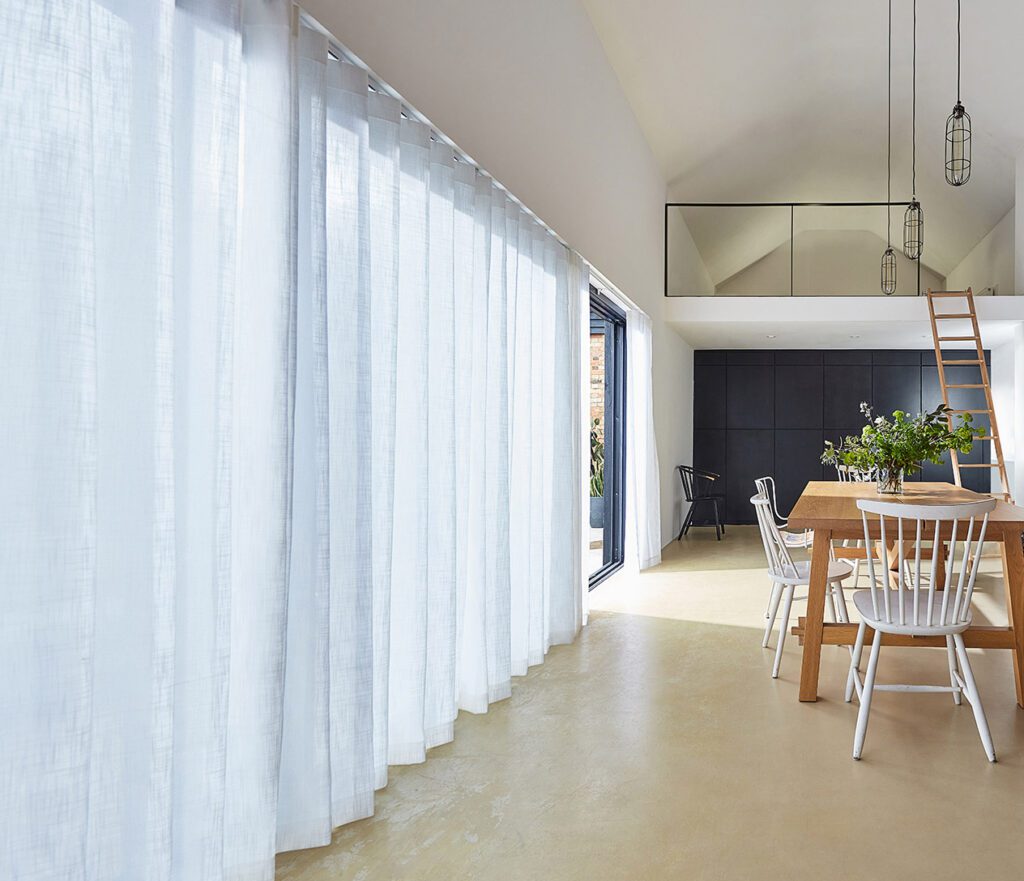 The best blinds and curtains for sliding doors include s-fold curtains (shown here), privacy sheers and panel glide blinds