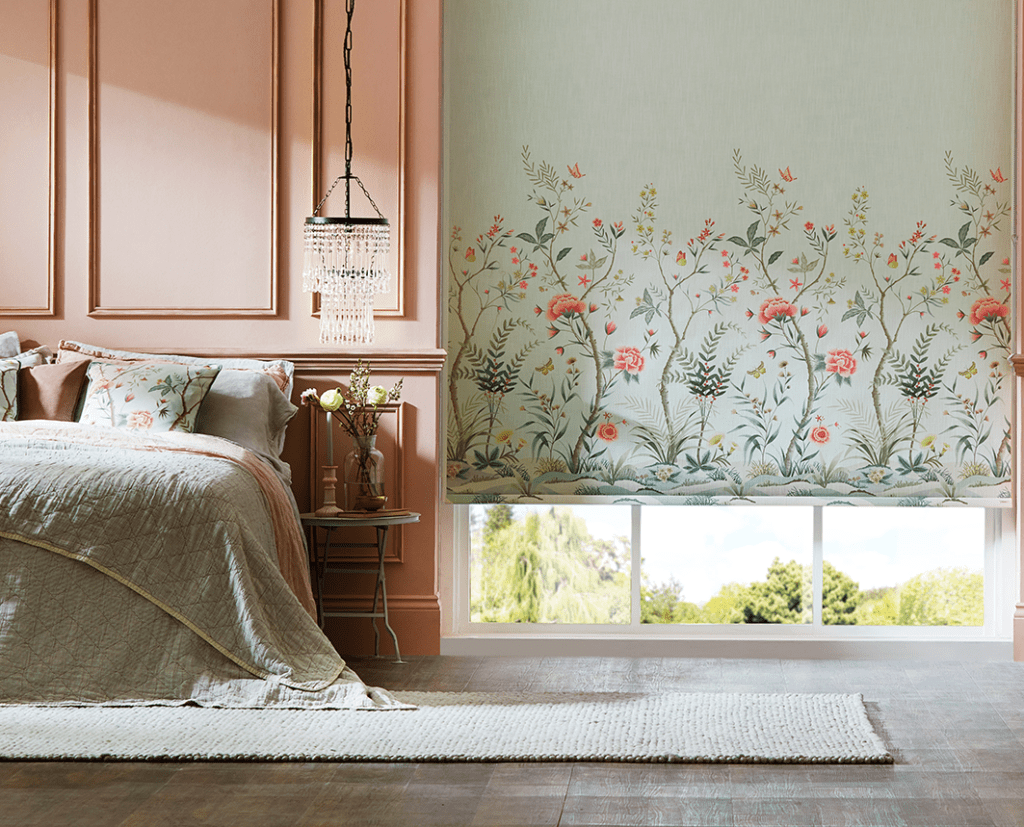 A beautifully patterned roller blind with a chinoiserie design at the bottom of the blind, trailing upwards. 