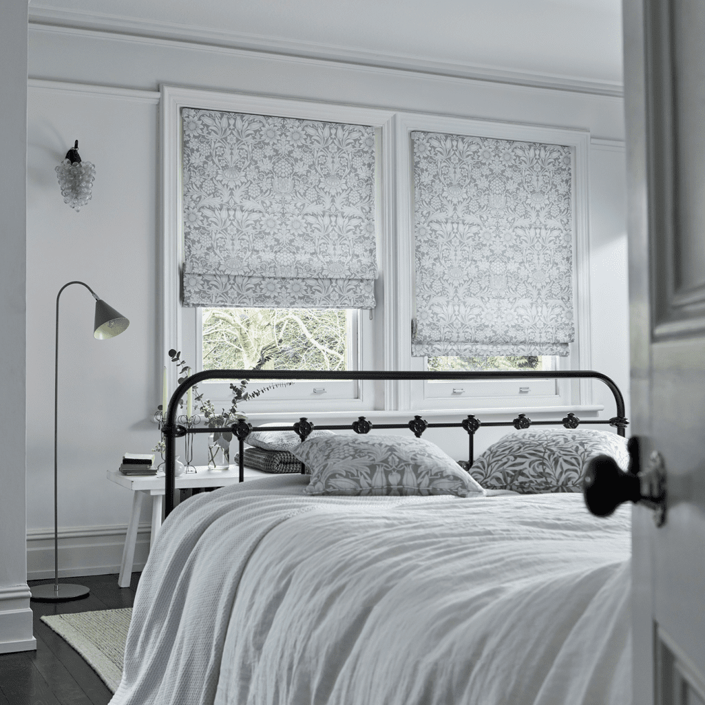 Blockout roman blinds in a William Morris print shown in a bedroom