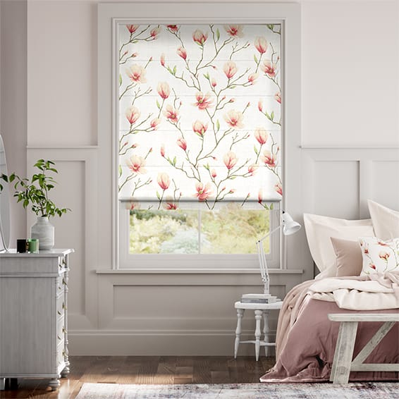 This bedroom window is covered with a roman blind featuring a pattern of delicate magnolia flowers. 