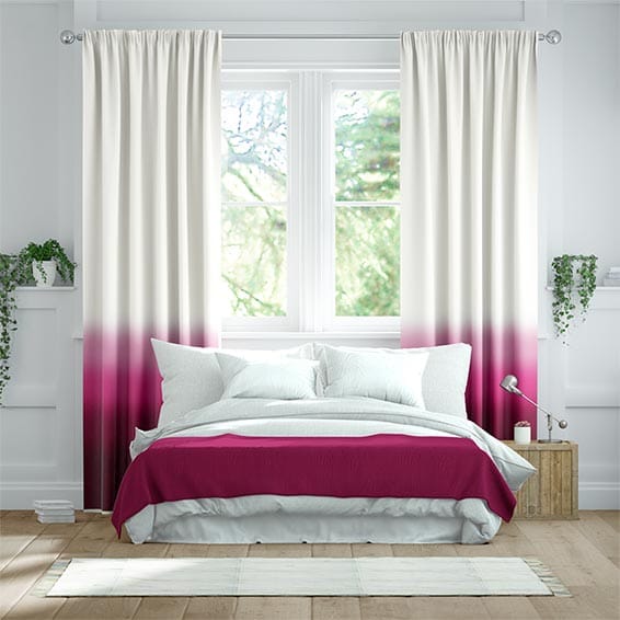 Pink ombre curtains hang behind a bed in this two-tone interior. 