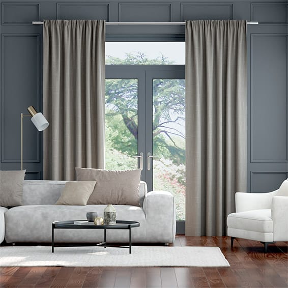 Pencil pleat curtains shown in a living room interior