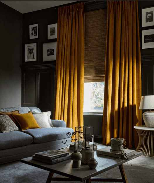 Living room showing antique gold velvet curtains layered with a bamboo roman blind. 