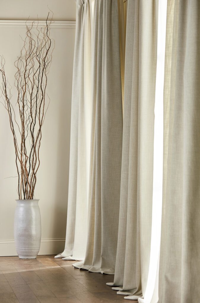 Pinch pleat curtains in a neutral colour fabric